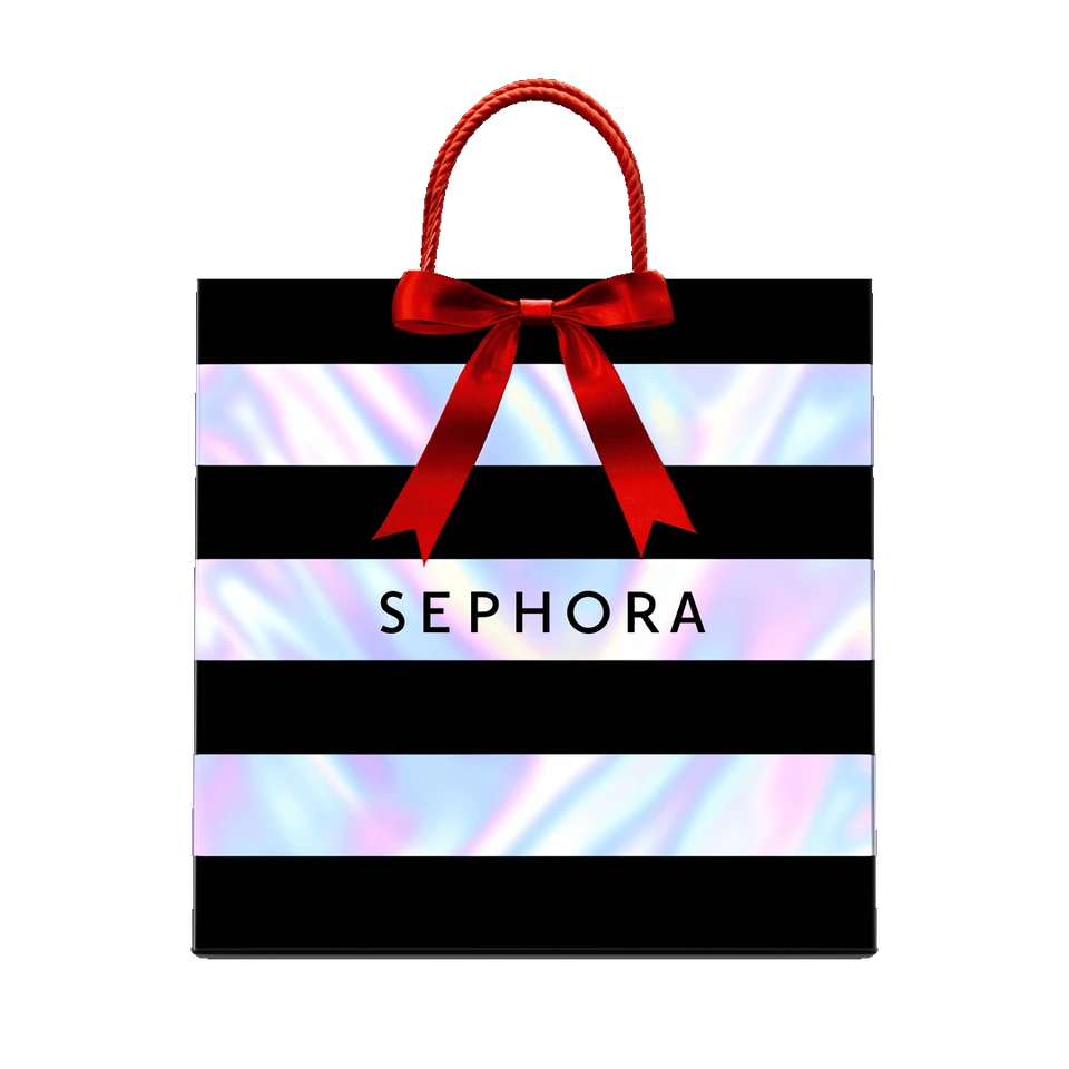 The Sephora holiday bag, with iridescent stripes, rope handles and a red ribbon.
